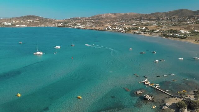 Aerial drone video of sandy beach blue sea water, clear blue sky Paros island Cyclades, Greece