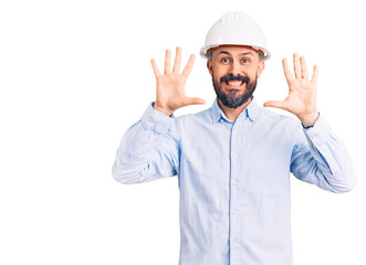 Young handsome man wearing architect hardhat showing and pointing up with fingers number ten while smiling confident and happy.