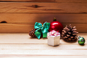 christmas greeting card. christmas decoration and gift box on a wooden background. copy space