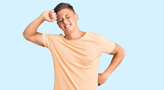 Young handsome man wearing casual clothes stretching back, tired and relaxed, sleepy and yawning for early morning