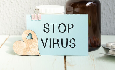 Text Stop Virus with thermometer and test tube on white background