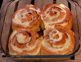 Obraz na płótnie Canvas Homemade Cinnabon buns with cinnamon and sweet glaze for evening tea
