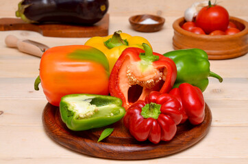 ingredients for cooking a vegetable dish cut bell pepper on a cutting board and other products on the kitchen table 