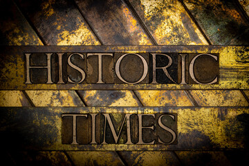 Historic Times text formed with real authentic typeset letters on vintage textured grunge copper background