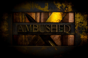 Ambushed text formed with real authentic typeset letters on vintage textured grunge darkened copper...