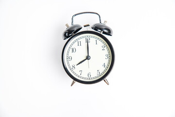 black alarm clock with white dial, shows 8.00 on a white background