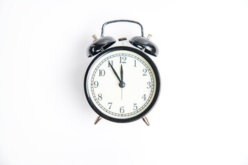 black alarm clock with white dial,11:55, isolate on white