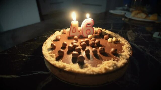 Birthday candle on a birthday cake for 46th birthday
