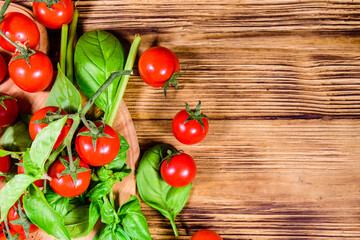 Heap of small cherry tomatoes on wooden table. Top view