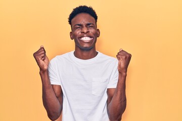 Young african american man wearing casual clothes excited for success with arms raised and eyes closed celebrating victory smiling. winner concept.