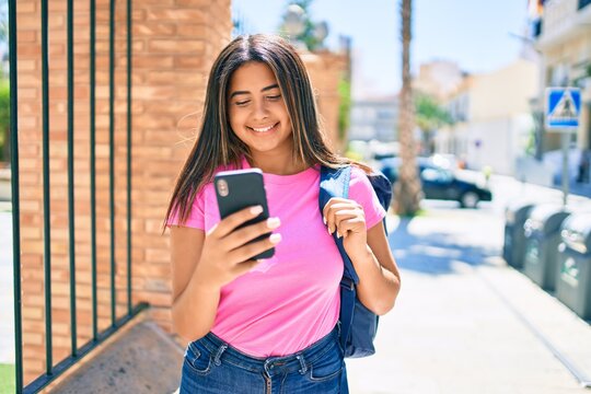 Young latin student girl smiling happy using smartphone at university campus.