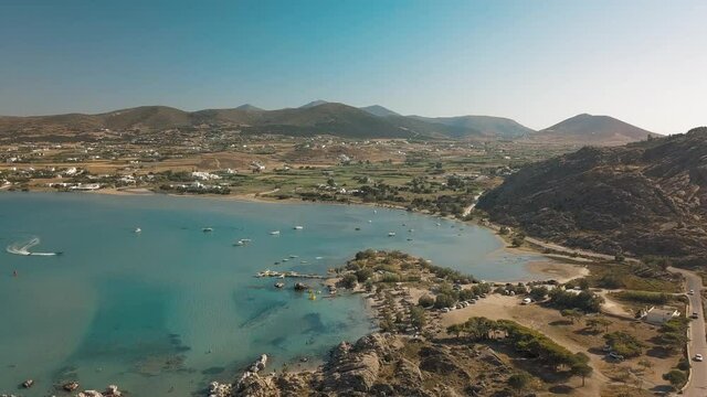 Aerial drone video of sandy beach blue sea water, clear blue sky Paros island Cyclades, Greece