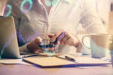 Double exposure of forex chart sketch hologram and woman holding and using a mobile device. Financial market concept.