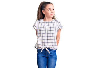 Fototapeta premium Cute hispanic child girl wearing casual clothes smiling looking to the side and staring away thinking.