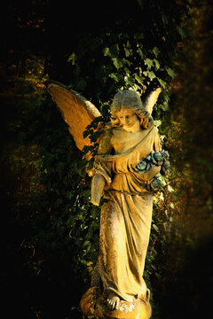 Beautiful sad angel. Ancient statue. Vertical image.