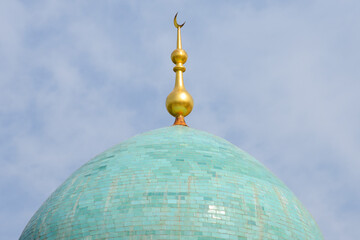 Fototapeta na wymiar Close view of a turquoise dome and golden ornament the Star and Crescent moon. Blue cupola. Representation os islamic religion in Tashkent, Uzbekistan