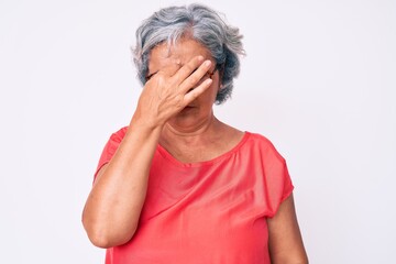 Senior hispanic grey- haired woman wearing casual clothes and glasses tired rubbing nose and eyes feeling fatigue and headache. stress and frustration concept.