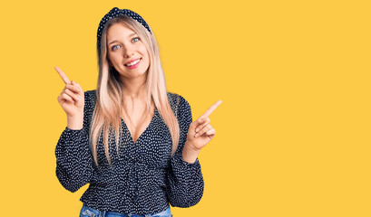 Young beautiful blonde woman wearing casual clothes smiling confident pointing with fingers to different directions. copy space for advertisement