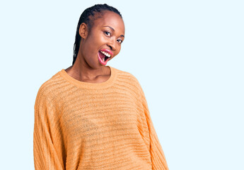 Young african american woman wearing casual clothes winking looking at the camera with sexy...