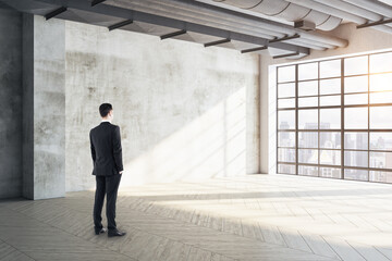 Businessman standing in exhibition hall interior