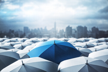 Blue umbrella on top of other gray umbrellas