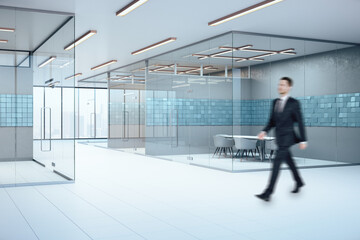 Businessman walking in conference interior with abstract blue tiles