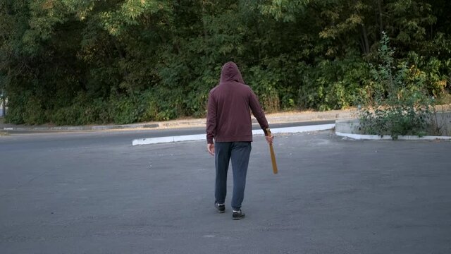 A man with a bat in his hands goes to organize a pogrom and mayhem. Rebellion