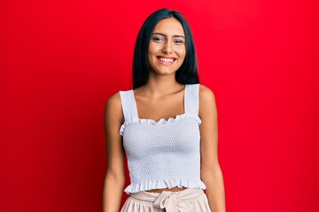 Young brunette woman wearing casual clothes with a happy and cool smile on face. lucky person.