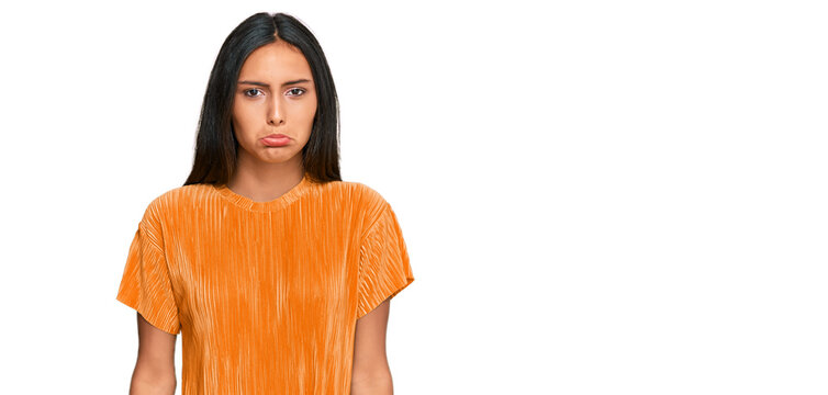 Young brunette arab woman wearing casual clothes depressed and worry for distress, crying angry and afraid. sad expression.