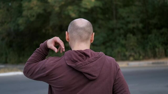 man with bat iputs on the hood and goes to organize a pogrom and mayhem