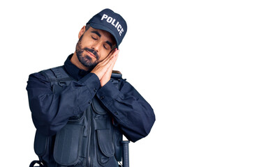 Young hispanic man wearing police uniform sleeping tired dreaming and posing with hands together while smiling with closed eyes.