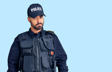 Young hispanic man wearing police uniform skeptic and nervous, frowning upset because of problem. negative person.