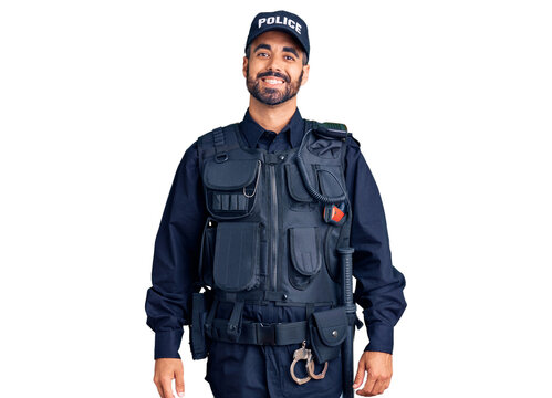 Young hispanic man wearing police uniform with a happy and cool smile on face. lucky person.