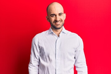 Young handsome bald man wearing elegant shirt with a happy and cool smile on face. lucky person.