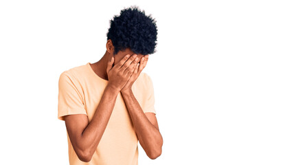 Young african american man wearing casual clothes with sad expression covering face with hands while crying. depression concept.