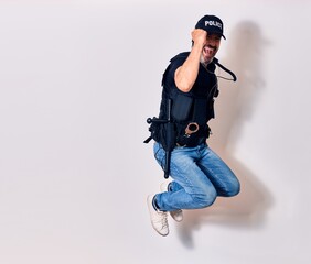 Middle age handsome man wearing police unifrom smiling happy. Jumping with smile on face doing ok sign with fists up over isolated white background