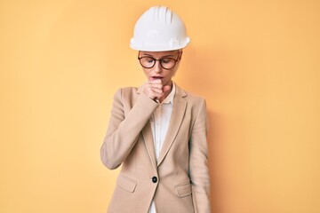 Young blonde woman wearing architect hardhat feeling unwell and coughing as symptom for cold or bronchitis. health care concept.