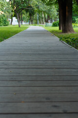 Fototapeta na wymiar Wooden walkway in the park, blurred image.