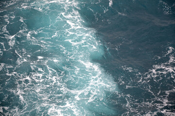 Fototapeta na wymiar Sea and ocean white foam, blue and green waves, rocks, blue water from Monaco
