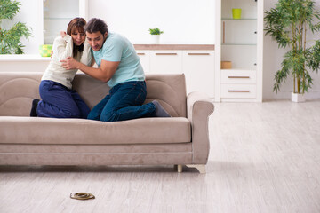 Young couple and snake in the flat