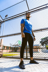 portrait of young athletic hispanic man wearing sportswear on a sunny day.