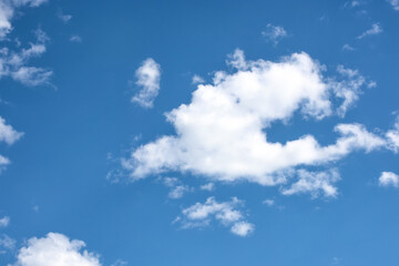 Obraz na płótnie Canvas Fluffy white clouds on background of blue sky.
