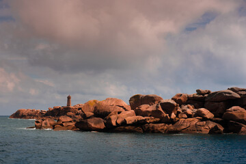 Men Ruz lighthouse and pink granit coast boulder in Brittany