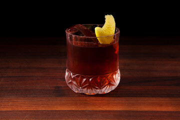 Vieux Carre cocktail on a walnut bar top.