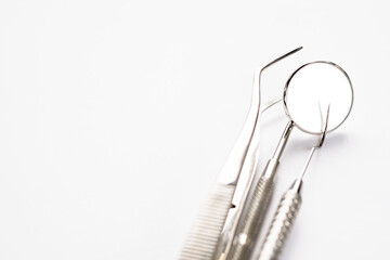 Basic dentist tools on white background.