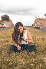 Young woman sitting on a rock in nature