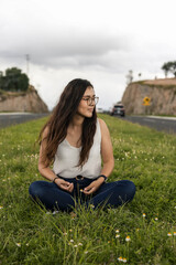 Young woman sitting on a rock in nature