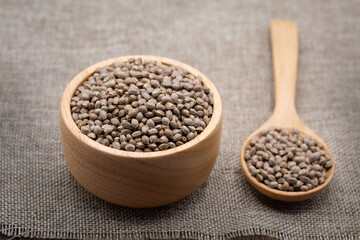  Hemp seeds in wooden spoon on brown wooden table. medical marijuana concept, CBD cannabis OIL.