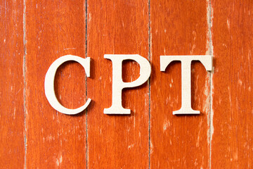 Alphabet letter in word  CPT (Abbreviation of Carriage Paid To) on old red color wood plate background