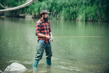 Portrait of cheerful bearded man fishing. Fun and relax. Fly fishing adventures. Hobby and sport activity. Portrait of man on holiday. Fisherman fishing equipment. Handsome man relaxing.